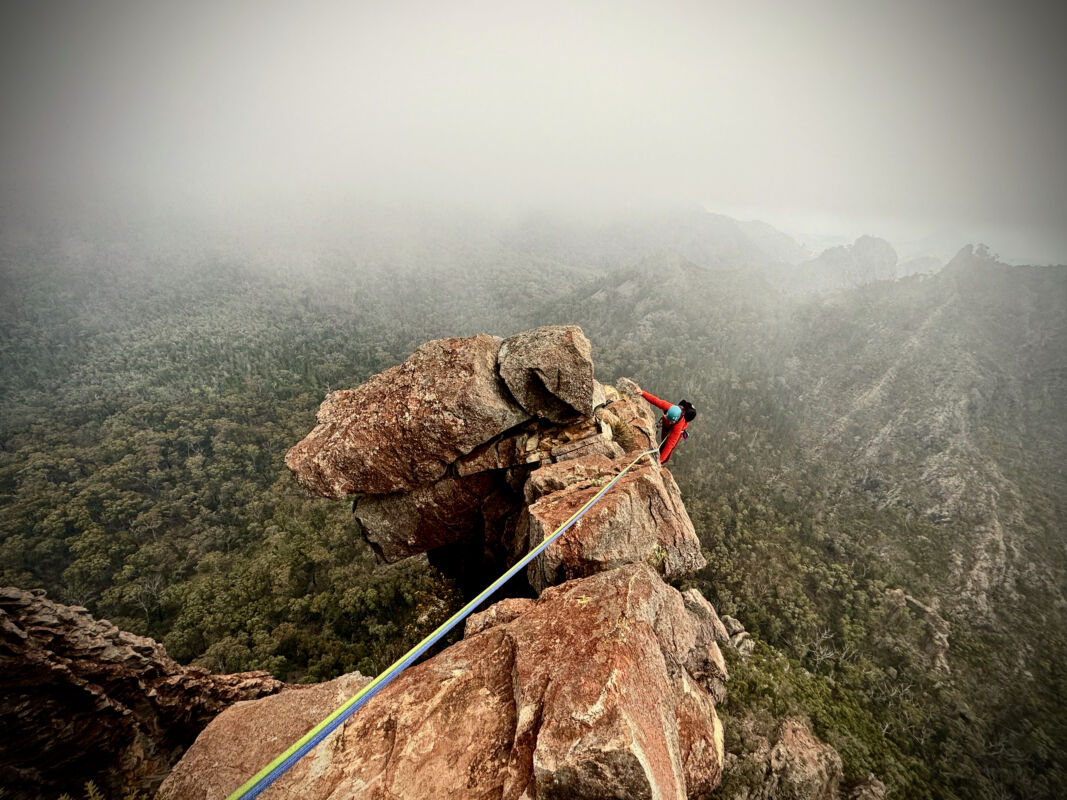 The climber in this picture is a tiny spec of colour against the backdrop of the volcanic rock she is climbing and the ominous cloudy weather surrounding her. It looks intense and it was!